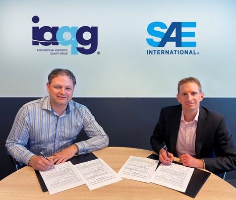 IAQG President, Andy Maher, BAE Systems signs the global standards publisher agreement with David Alexander, Mobility Standards Leader, SAE International