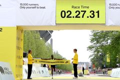 Margaret Agai from Kenya crosses the line and receives the yellow ribbon of triumph in Copenhagen