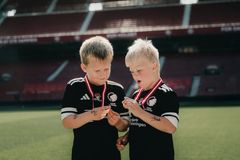 Alle børn var vindere på fodboldskolen, og der var således medaljer til alle. Her studerer to unge herrer deres medaljer.