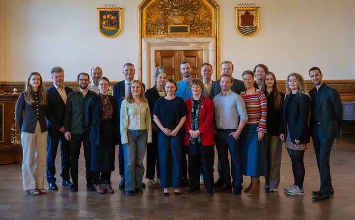 Billede af partierne bag overførselssagen samlet i festsalen efter forhandlingerne.