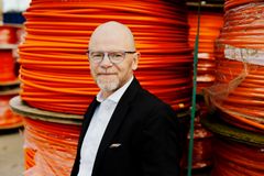 Carsten Bryder, direktør for Norlys' fiberforretning foran fiberkabler