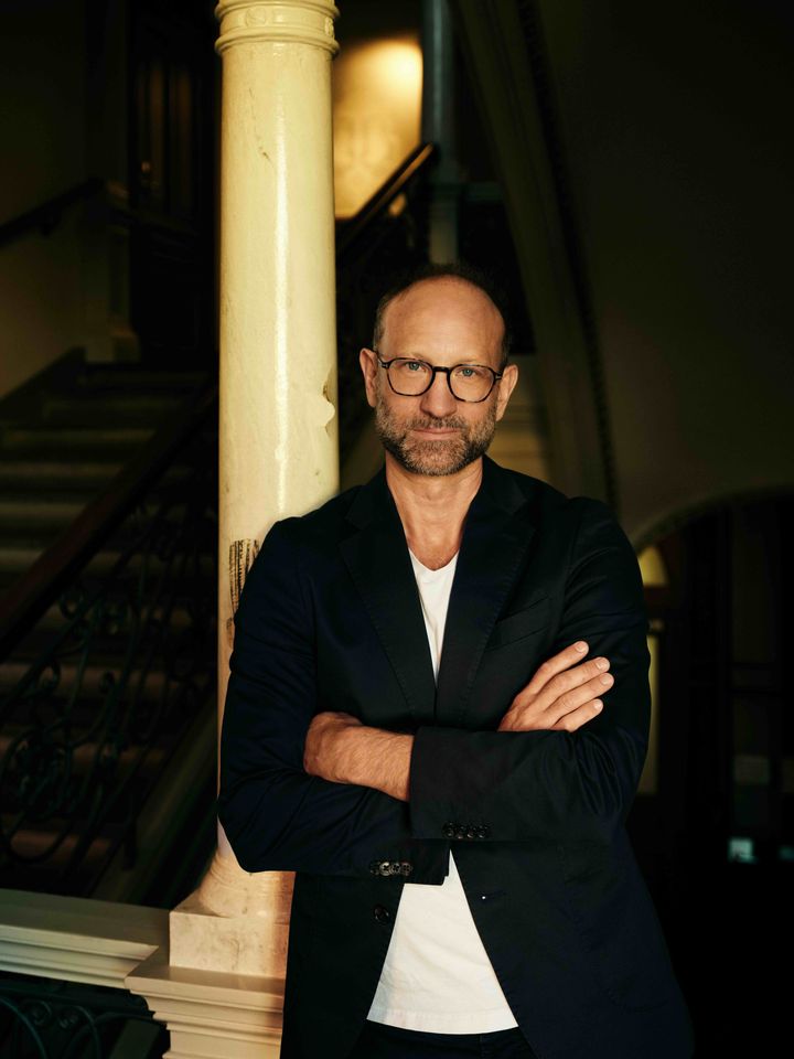 Portræt at forfatter Christian Unge, der står med korslagte arme.