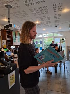 Billede af Christoffer, der læser op fra en bog