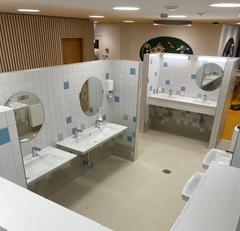 Alt text: Billede af moderne tandklinik på Nørrebrogade med flere vaskestationer og runde spejle.