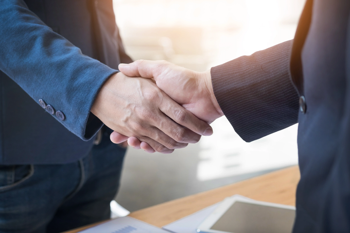 Two people shaking hands.