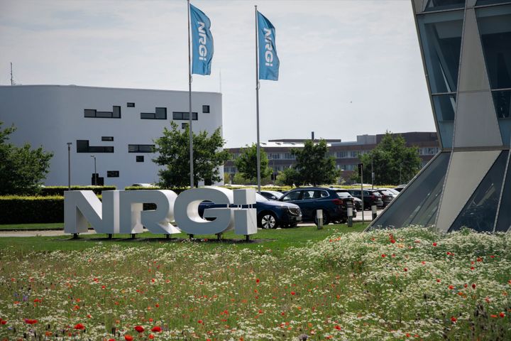 NRGi’s hovedkontor med NRGi-logo og flag foran bygningen.