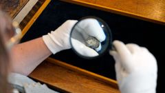 One of the coins seen through a magnifying glass. Photo: John Fhær Engedal Nissen, the National Museum of Denmark.