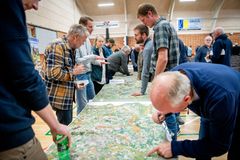 Gruppe af mennesker samlet omkring et stort kort ved en konference i Tønder om fremtidens landskab og arealanvendelse.