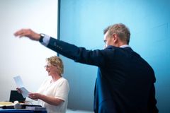 En mand udfører en underholdningsakt for en kvinde, som læser et papir.