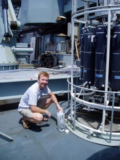 Professor Lasse Riemann taking water samples on a research cruise.