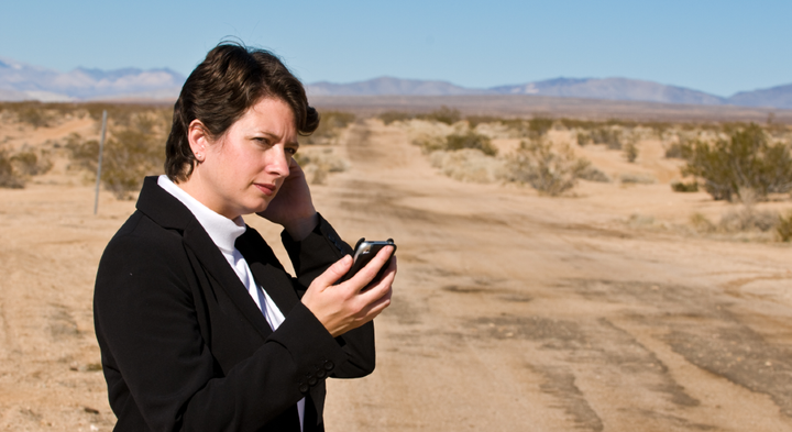 Woman in desert appears to speak to her phone