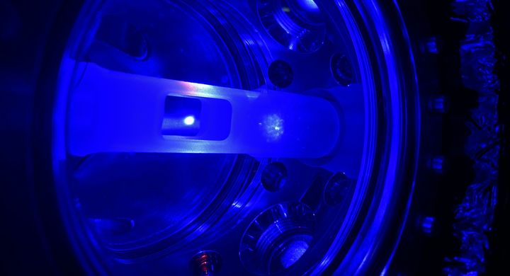 The luminous ball in the middle, called a "magneto-optical trap" (MOT),  consists of approximately 300 million strontium atoms suspended in a vacuum chamber cooled to just above absolute zero. This trap was used by researchers to develop new techniques for measuring time. Photo: Eliot Bohr