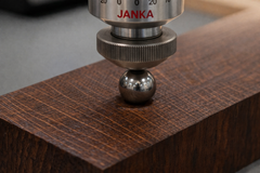 The image shows a “Janka test,” which is the standardized method for measuring the surface hardness of wood. Hyperlignification increases surface hardness, which will likely reduce attacks from termites and other small organisms that feed on wood.