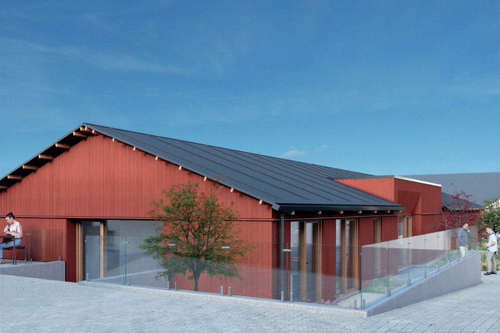 Rød træbygning med sort tag