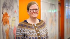 Portræt af kvinde foran kunstværk.