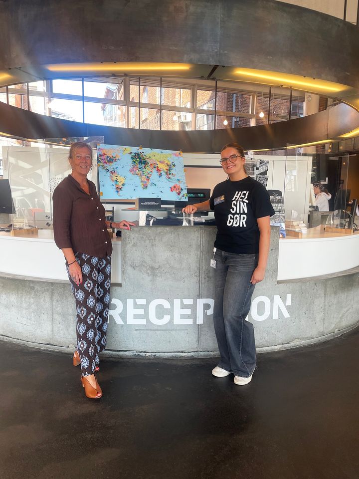 Turister fra hele verden: Bibliotekschef Birgitte Refbjerg Hansen og turistmedarbejder Dana Cueto viser stolt verdenskortet i Visitor Service frem. Her har turister hele sommeren kunne sætte en nål for at markere deres hjemland.