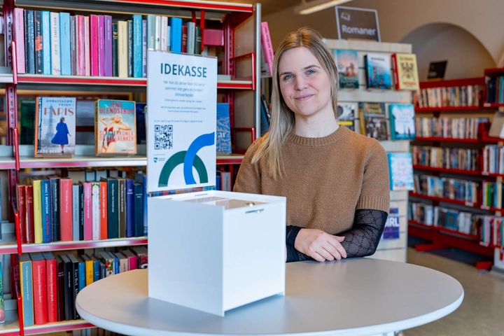 Foto af idékasse og medarbejder