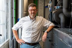 Gorm Elikofer, direktør for Energi i HOFOR, står ved siden af varmepumpe i HOFORs forsyningsbygning i Tietgensgade.