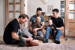 Fædre og børn hygger sig på gulvet