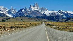 Øde vej i Patagonien med bjerge i baggrunden.
