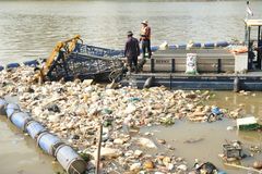 A waste collection vessel operated by everwave that collects plastic and debris from a river in Cambodia, thereby reducing the flow of waste into the ocean.
