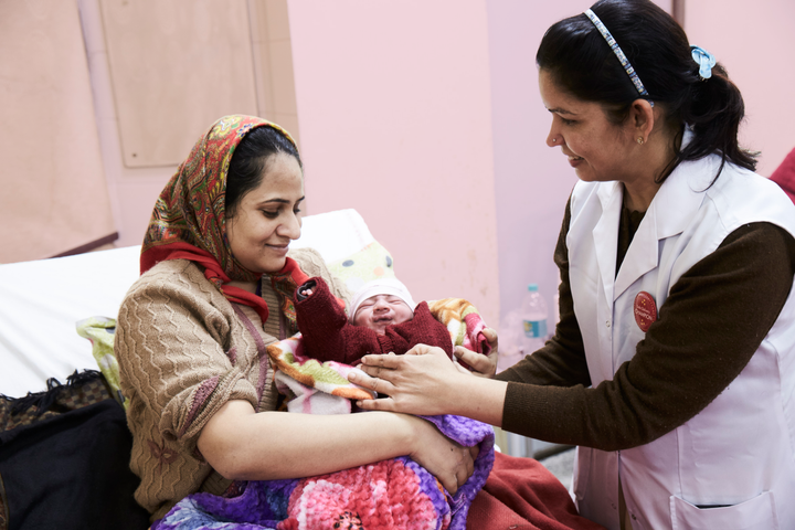 Jordemor, trænet af Maternity Foundation, tilser fødende kvinde i Indien