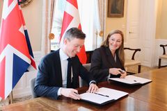 Elsebeth Søndergaard Krone, State Secretary for Development Policy at the Danish Ministry of Foreign Affairs, and Olaf Henricson‑Bell, Migration Director at the UK Foreign, Commonwealth & Development Office, sign the new UK–Denmark Memorandum of Understanding (MoU).