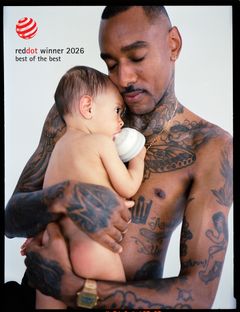 A man is embracing and feeding his baby