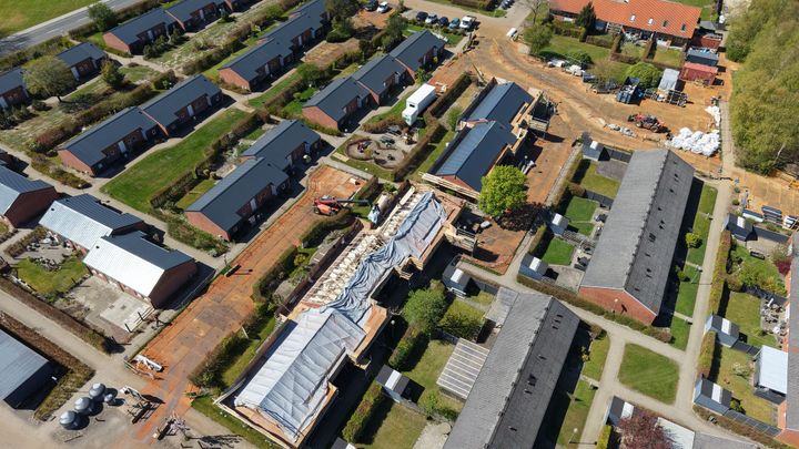 Luftfoto af boligrenovering i Brande Boligforening, med bygninger under opbygning og anlægsmaskiner synlige på byggepladsen.
