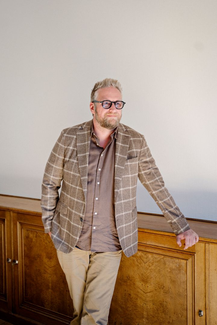Carsten Rasnussen, medstifter af Propbinder, står ved et træpanel.