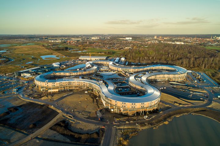 Når Nyt Hospital Nordsjælland tages i brug om et par år, bliver det med et delproduktionskøkken i servicebyen, som ses ved det fjerneste kløverblad, og som er forbundet med hospitalet via en 129 meter lang tunnel. Foto: Jonathan Grevsen, NCC.