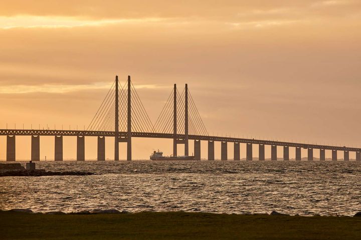 Broen Øresundsbron ved solnedgang over vandet.